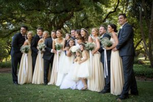 A semi-circular pose arrangement of the bridal party following the marriage of Alfie Skilleter and Elaina Mckinna-Judd in Hyde Park, North Perth